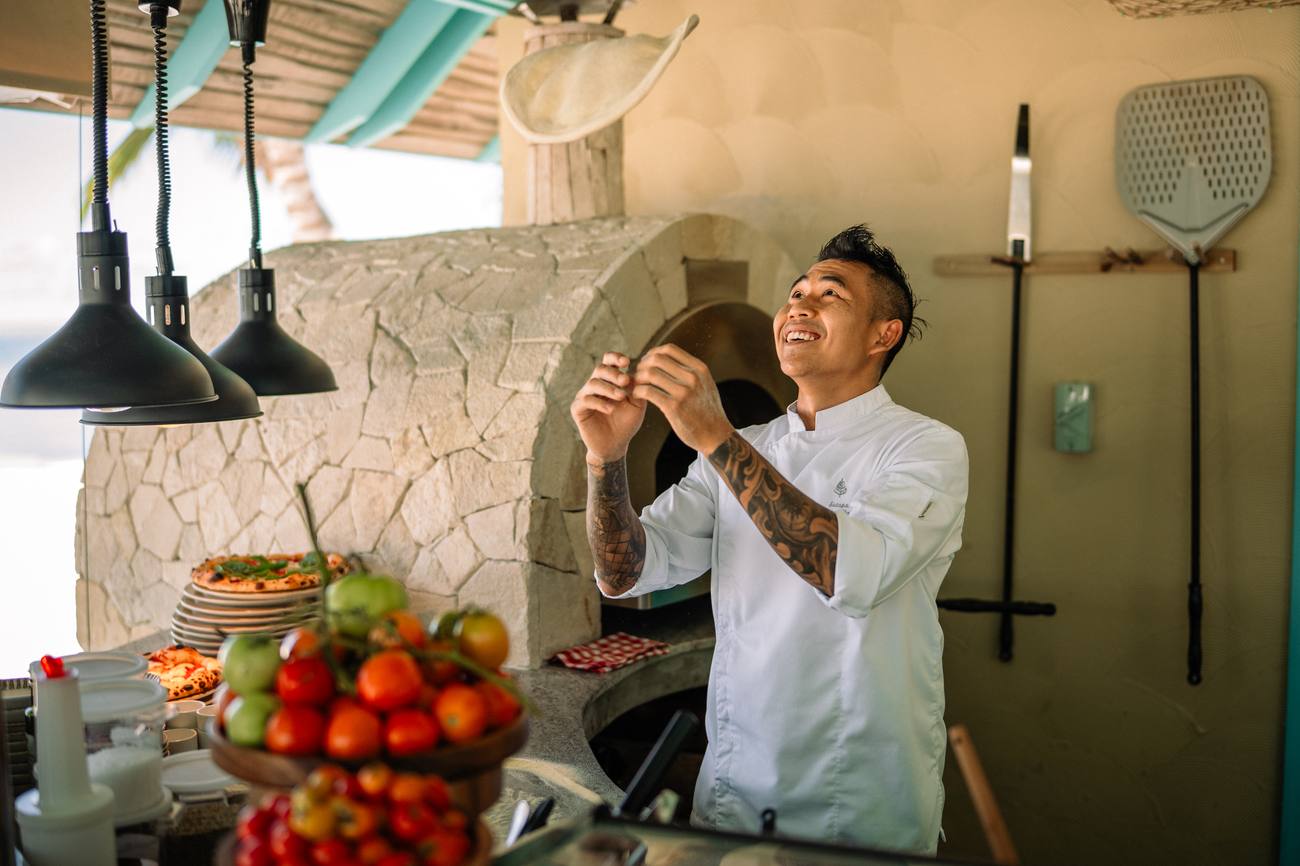 Chef tossing pizza dough