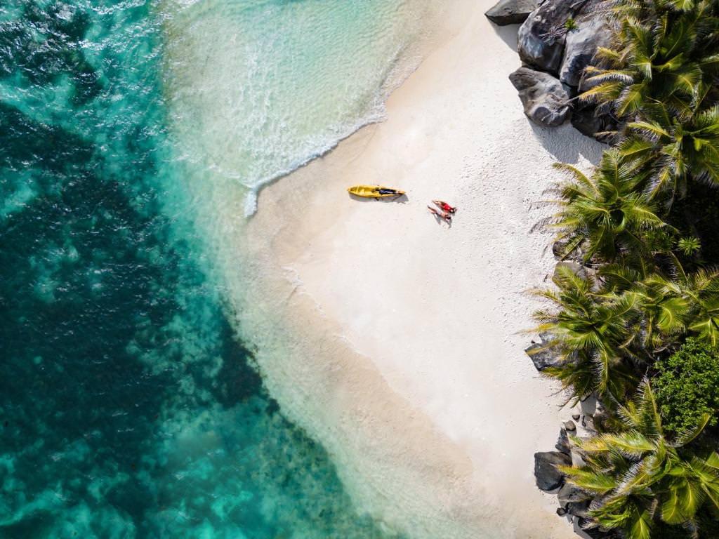 Aerial of a couple and kayak on a Round Island beach